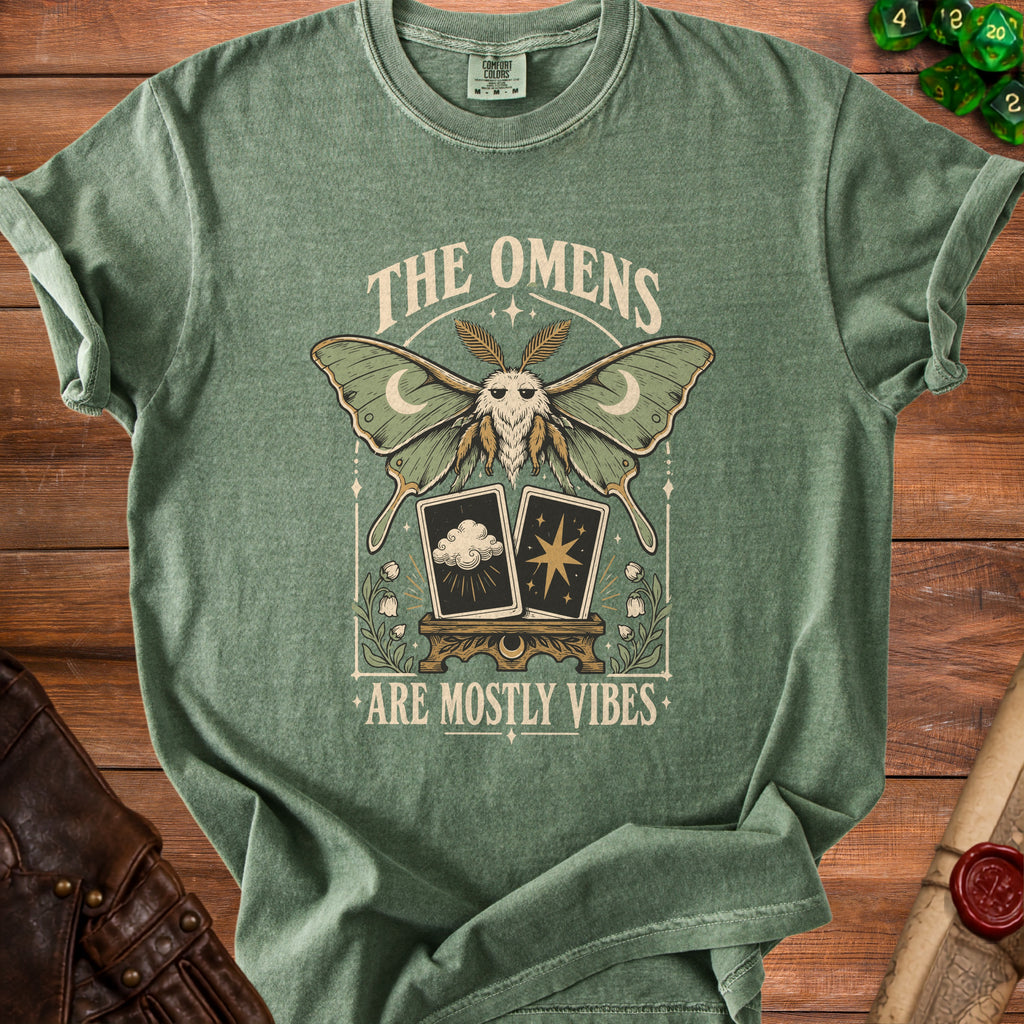 Green t-shirt with moth, moons, tarot cards, and text "The Omens Are Mostly Vibes".