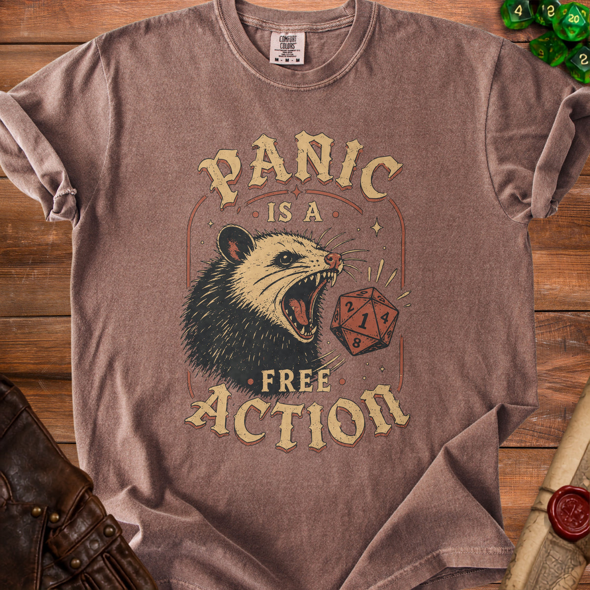 T-shirt with a graphic of a screaming possum and a d20 die reading "Panic Is A Free Action".