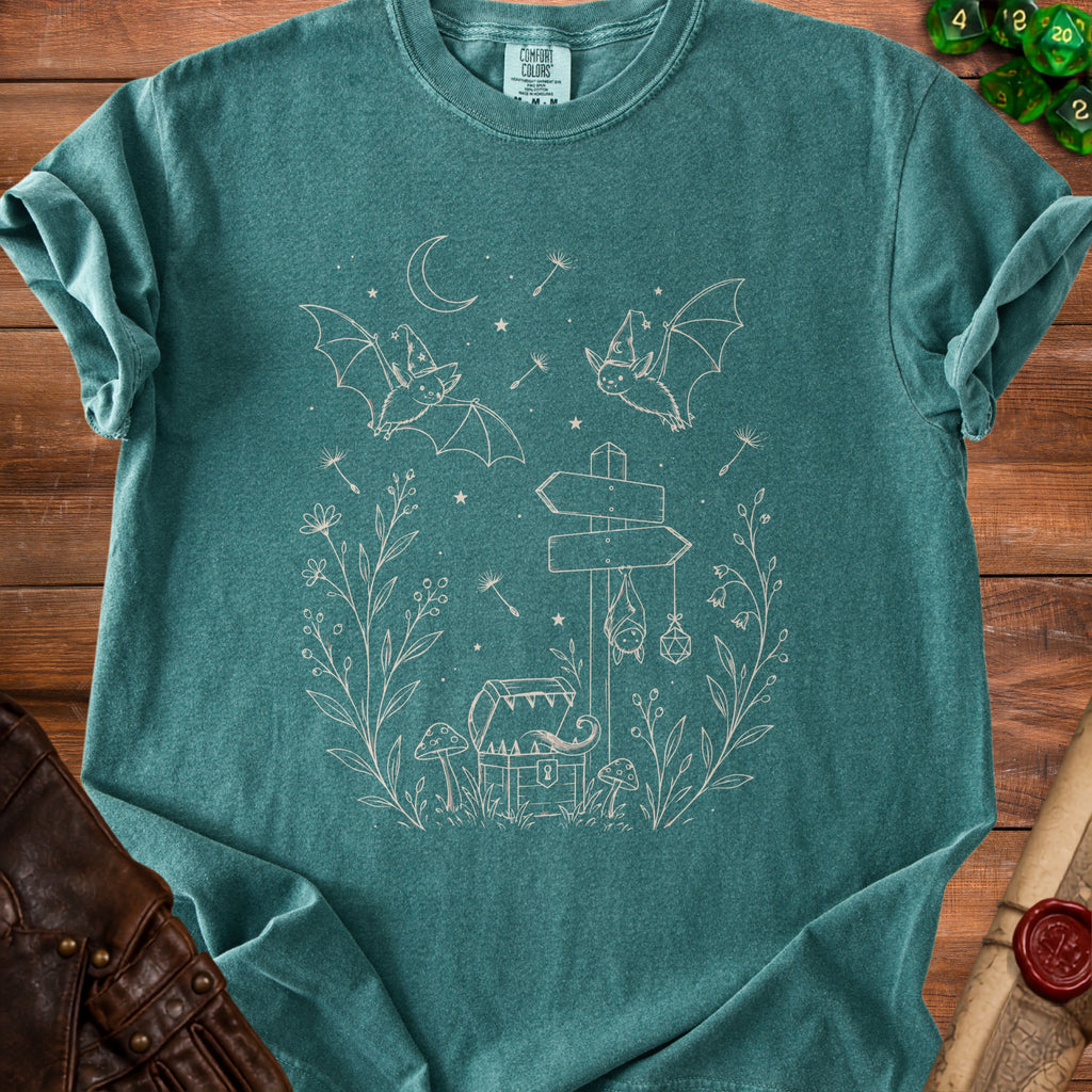 Teal t-shirt with line art of bats, chest, mushrooms, and celestial elements.