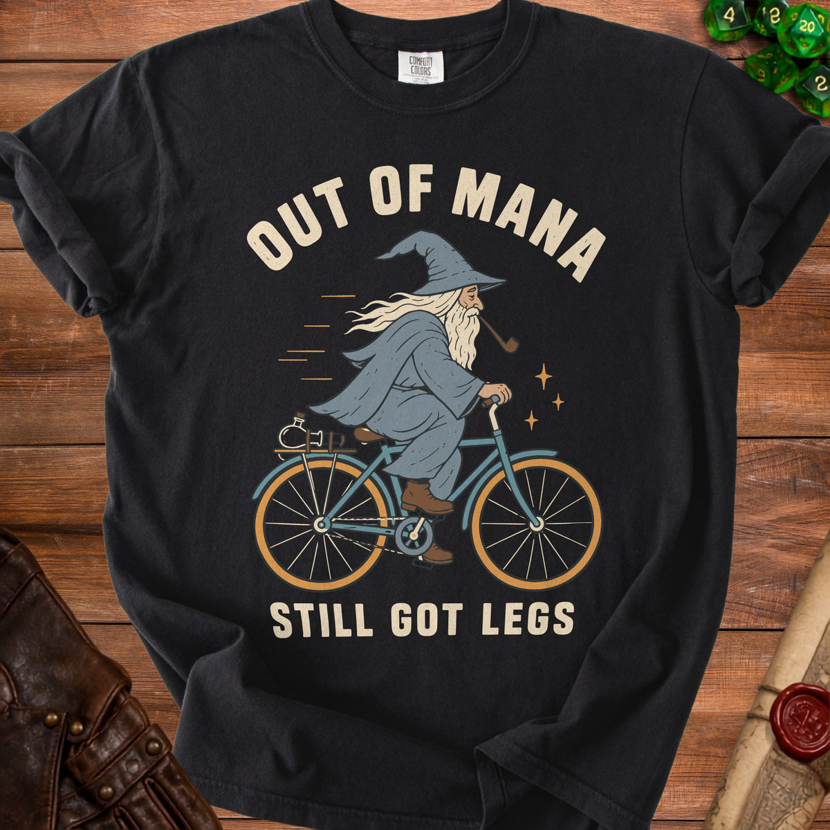Black t-shirt with wizard on bicycle graphic and text "Out of Mana Still Got Legs".