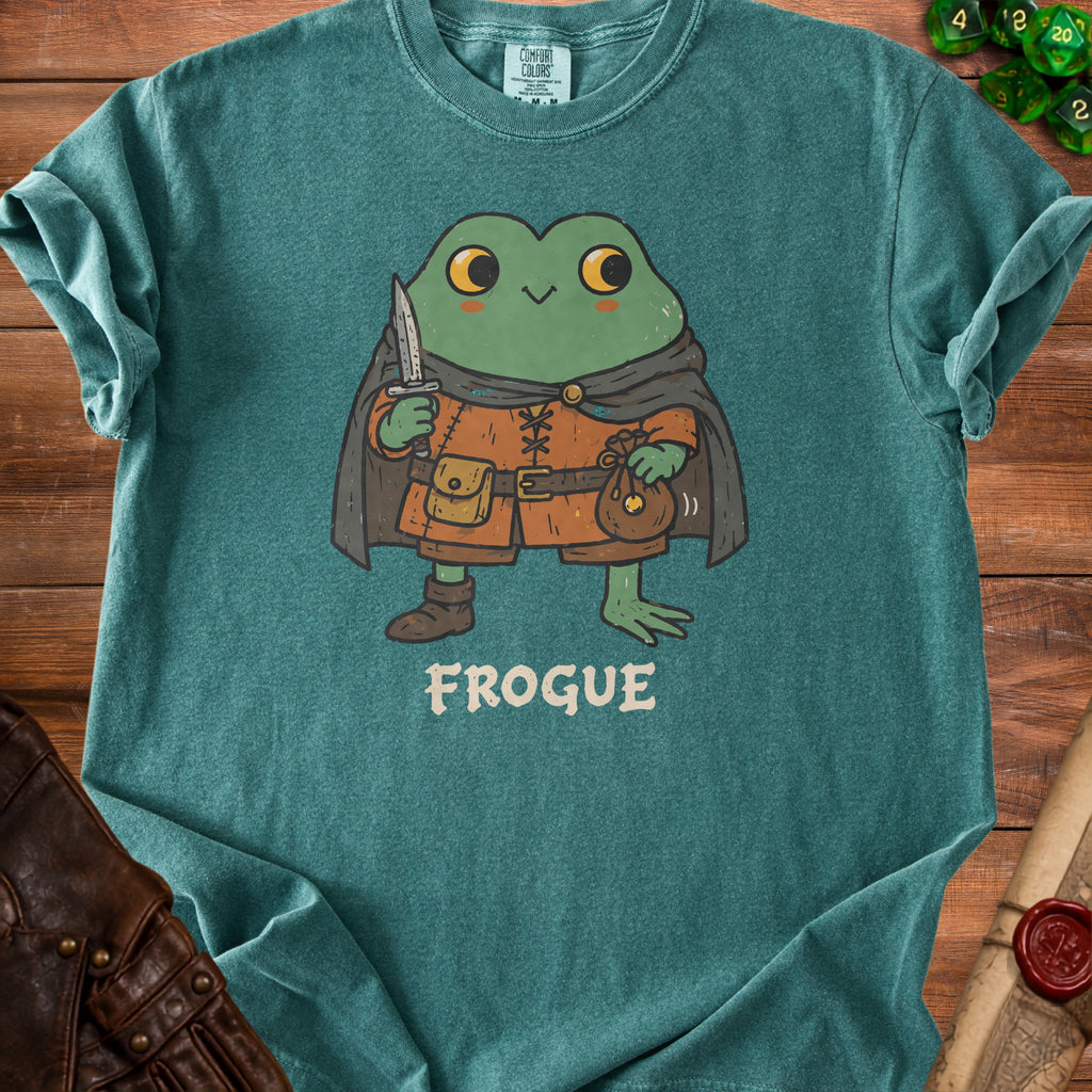 Teal t-shirt with cartoon frog character wearing a cape, holding a knife and coin pouch, labeled "FROGUE".