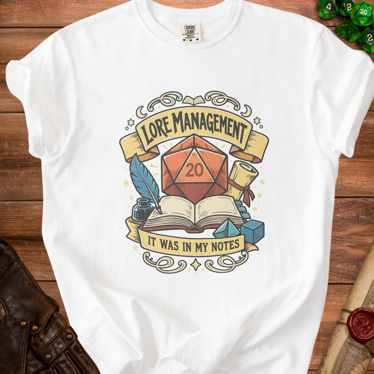 White t-shirt with a "Lore Management It Was In My Notes" graphic featuring a d20 die.