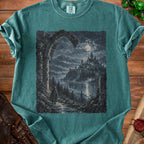 T-shirt with a dark fantasy castle and cloaked figure at night under a moonlit sky.