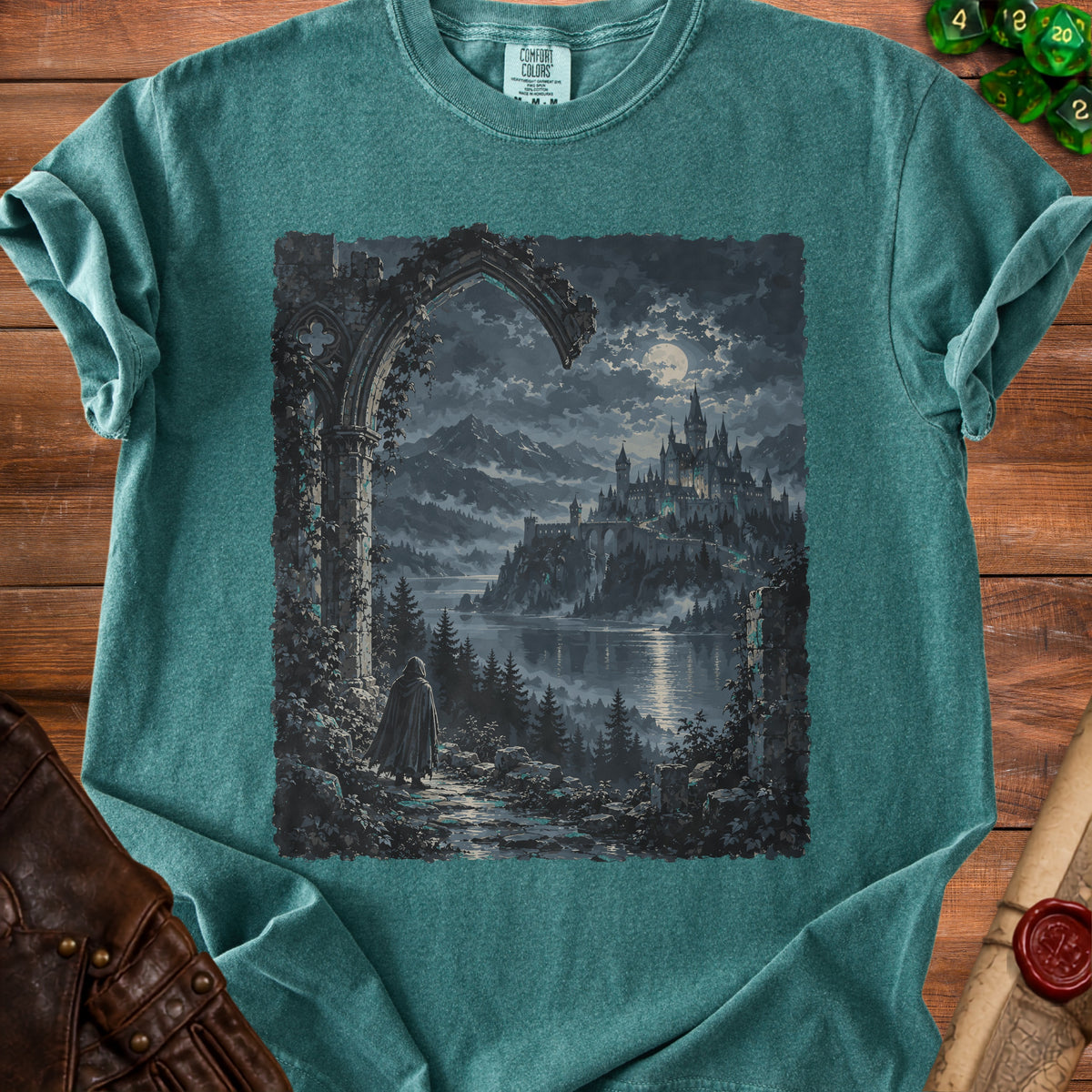 T-shirt with a dark fantasy castle and cloaked figure at night under a moonlit sky.