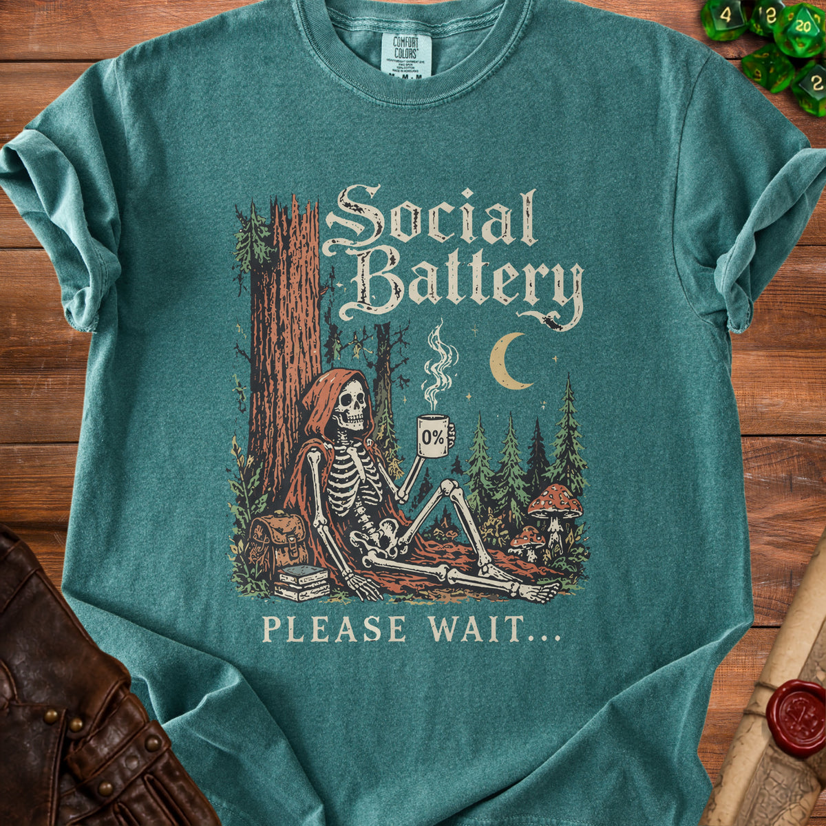 Skeleton in a forest drinking coffee with "Social Battery" and "Please Wait..." text.