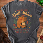 Dark gray t-shirt with a capybara graphic and text "WAY TOO MUCH Hullabaloo GOING ON THESE DAYS FOR MY LIKING".