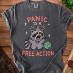 Dark gray t-shirt with raccoon graphic and text "PANIC IS A FREE ACTION".
