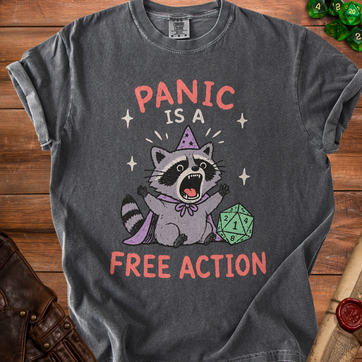 Dark gray t-shirt with raccoon graphic and text "PANIC IS A FREE ACTION".