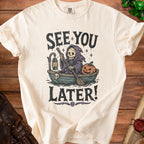 Cream t-shirt with graphic of grim reaper in a boat with pumpkin, text "See You Later!"