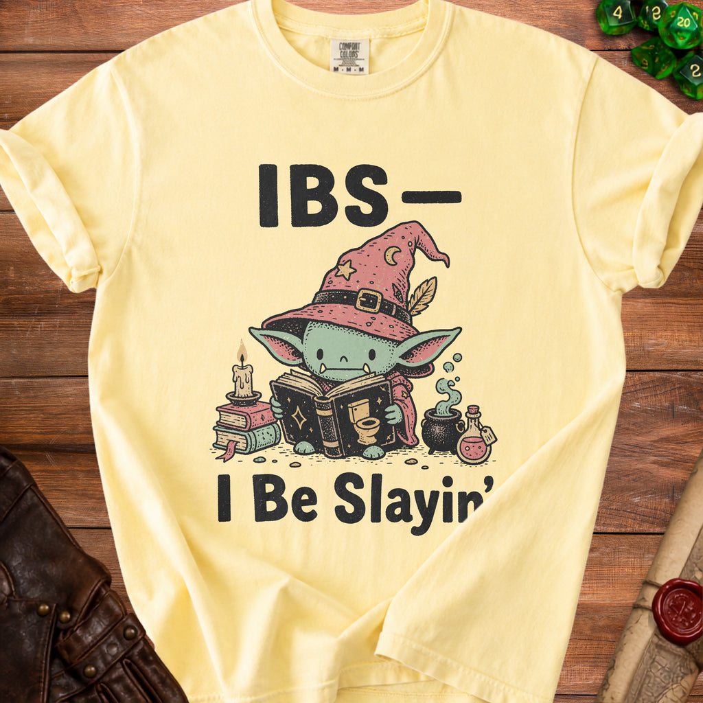 Yellow t-shirt with "IBS - I Be Slain'" text and wizard creature reading a book.