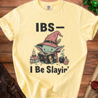Yellow t-shirt with "IBS - I Be Slain'" text and wizard creature reading a book.