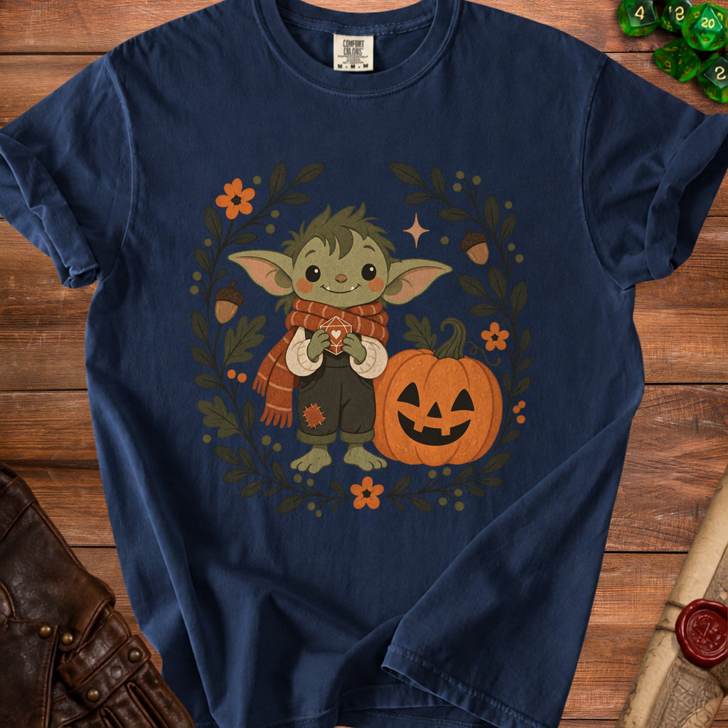 Navy t-shirt with a cute creature, pumpkin, and fall leaves graphic.