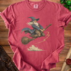 T-shirt with a vintage wizard flying on a broomstick and clouds.