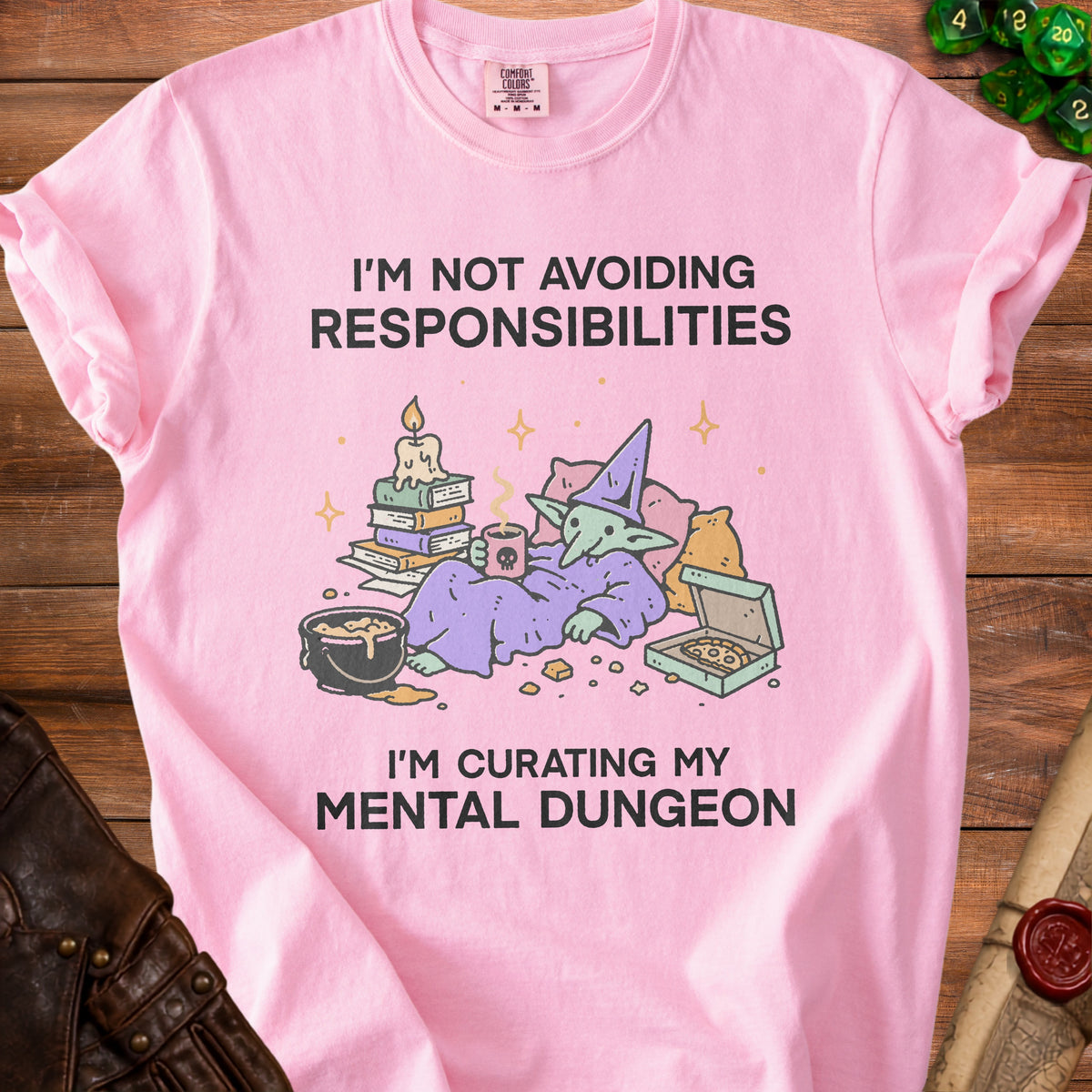 Pink t-shirt with illustration of a goblin and text "I'm not avoiding responsibilities I'm curating my mental dungeon".