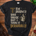 Black t-shirt with "The Prophecy Was Vague But I Took It Personally" text and wizard graphic.