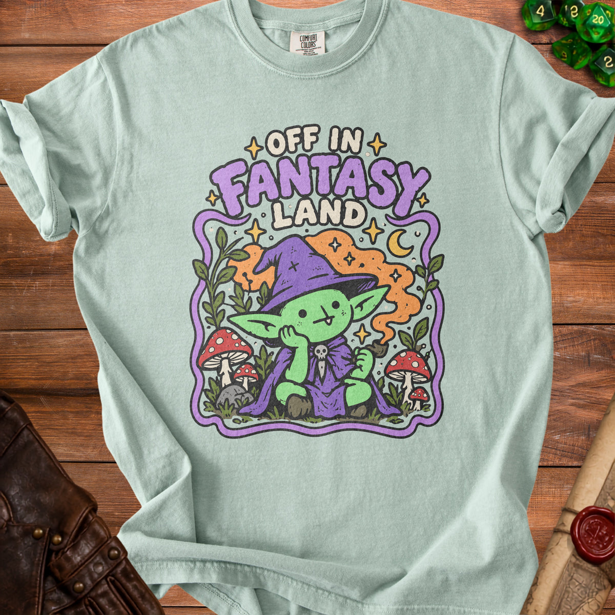 Light green t-shirt with "Off in Fantasy Land" text and a cartoon goblin character.