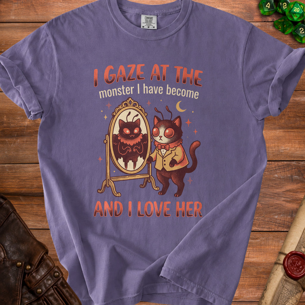 Purple t-shirt with a moth-like cat looking in a mirror, text reads "I GAZE AT THE monster I have become AND I LOVE HER".