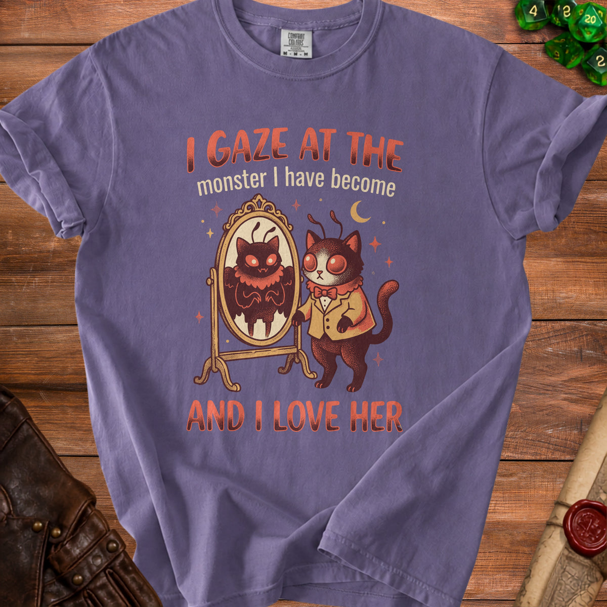 Purple t-shirt with a moth-like cat looking in a mirror, text reads "I GAZE AT THE monster I have become AND I LOVE HER".