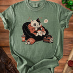 T-shirt with cartoon cat playing video games, bag of chips, and books.