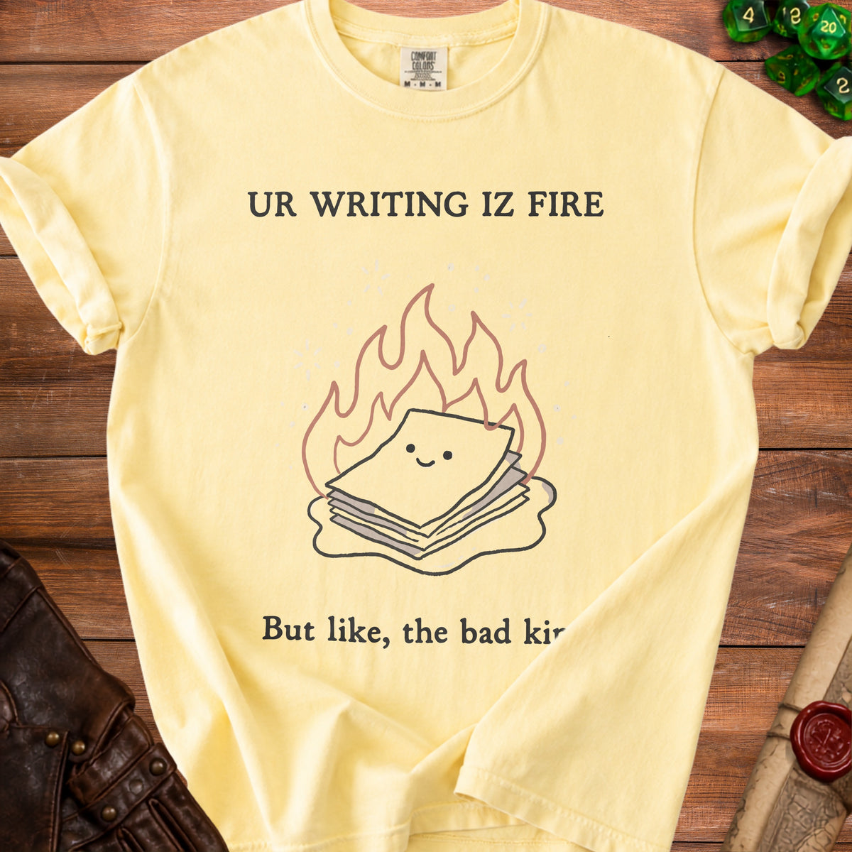Yellow t-shirt with "UR WRITING IZ FIRE" and a stack of papers in flames graphic.