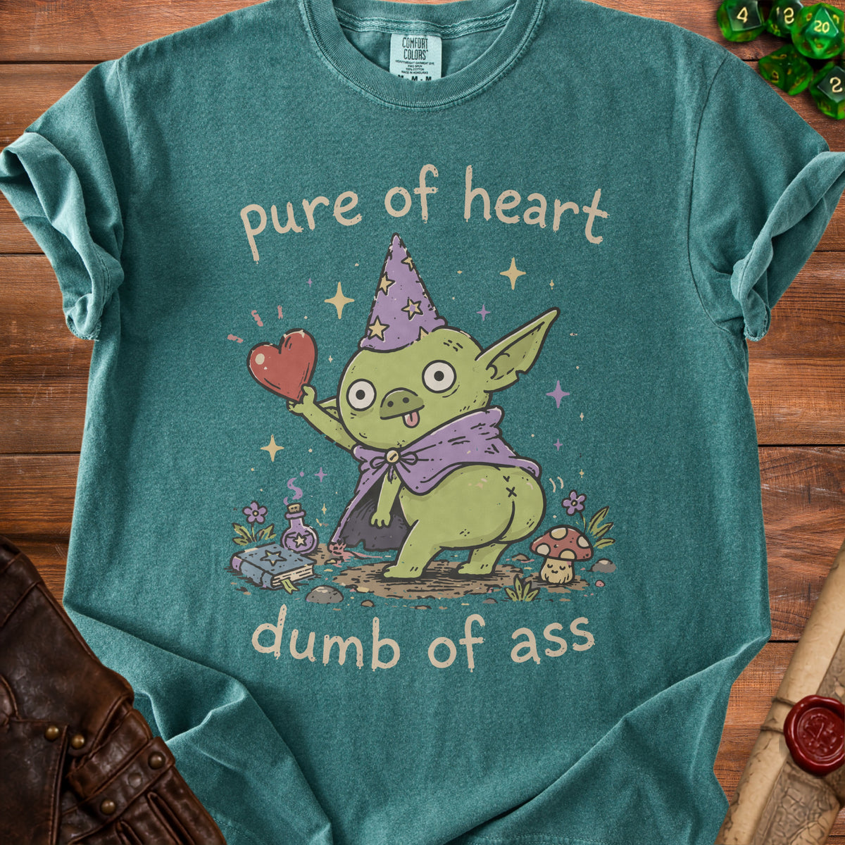 Green t-shirt with "pure of heart dumb of ass" text and a goblin holding a heart.