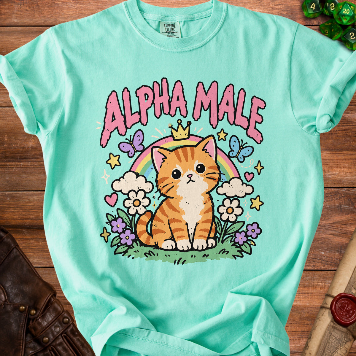 Teal t-shirt with cartoon cat wearing crown, butterflies, and text "ALPHA MALE".
