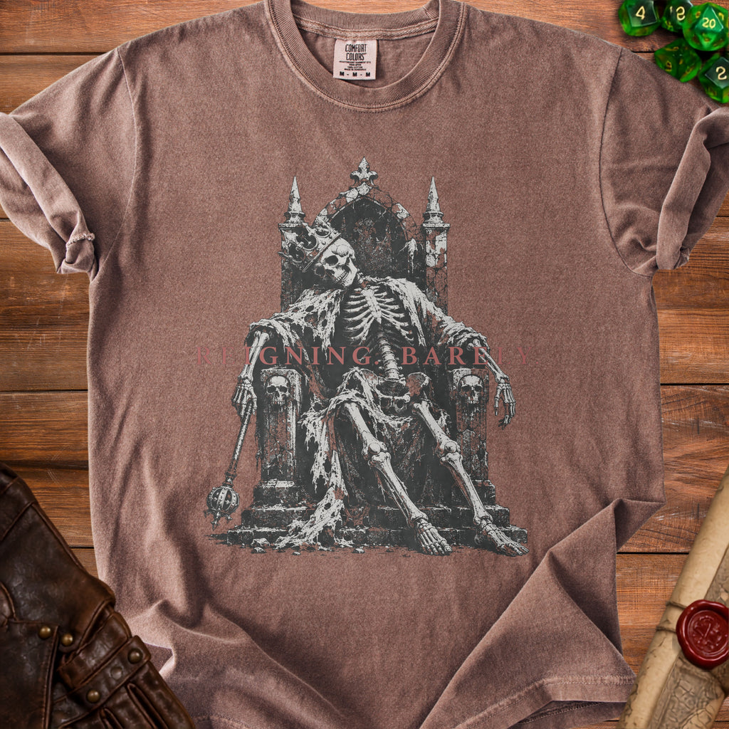 Brown t-shirt with skeleton king graphic and "REIGNING BARELY" text.