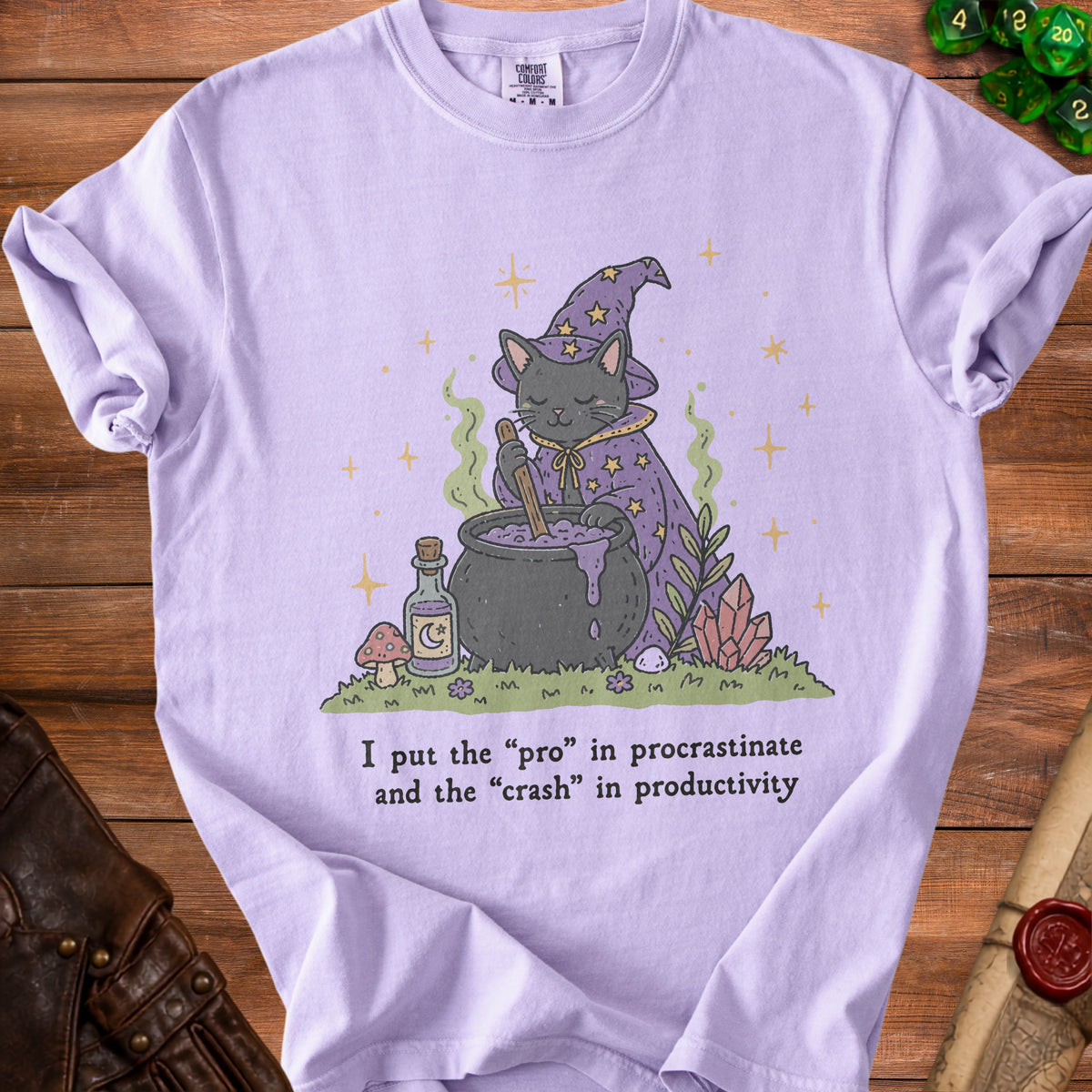 Lavender t-shirt with illustration of a witch cat, cauldron, and text.