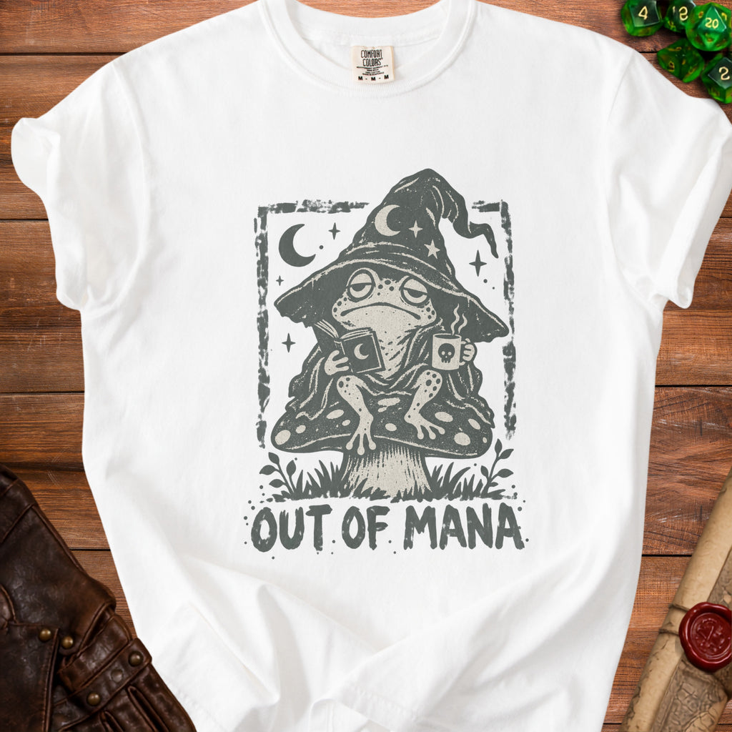 White t-shirt with a frog in a wizard hat, holding a book and mug, reading "OUT OF MANA".