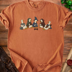 Orange t-shirt with a graphic of five ducks in fantasy costumes around a campfire.