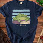 Dark blue t-shirt with a sleeping green frog on a book, "do not summon" text.