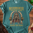 Teal t-shirt with skeleton deadlifting between stone arches, "Necromancer Deadlift Club" and "Raise the Dead" text.
