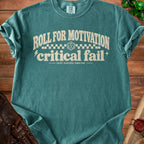 Teal t-shirt with "Roll for motivation, critical fail" text and dice.