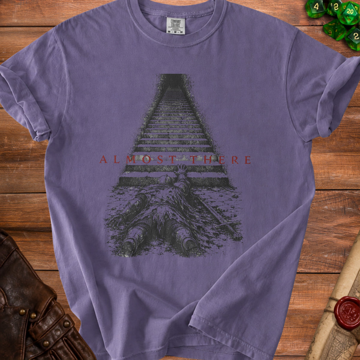 Purple t-shirt with knight and stairs graphic and text "ALMOST THERE".
