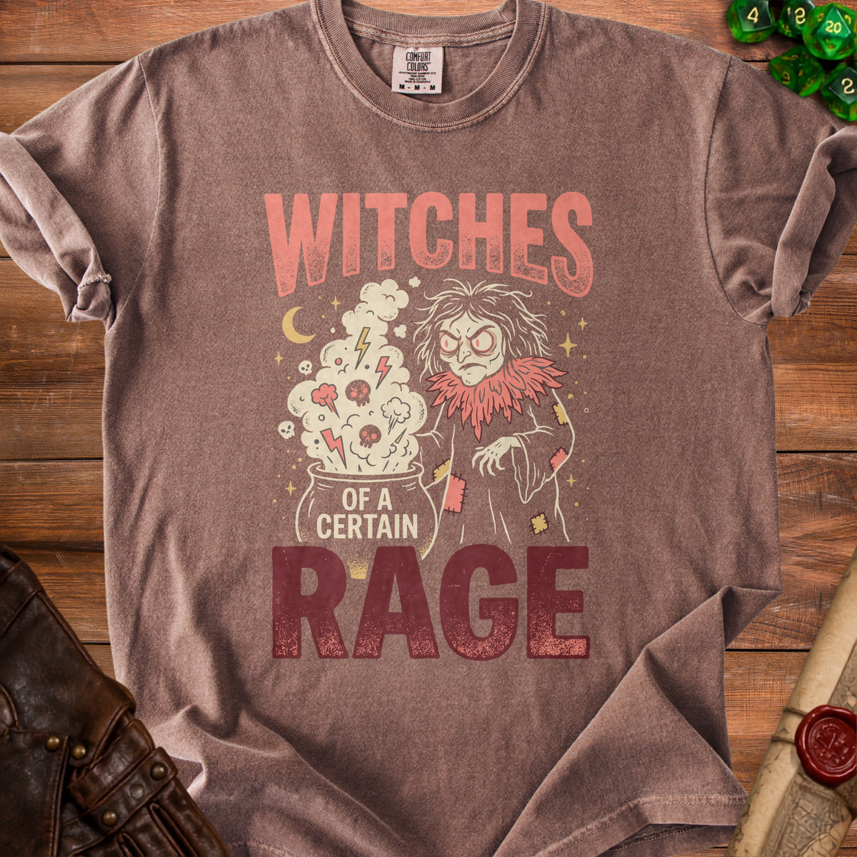 Brown t-shirt with "Witches of a Certain Rage" graphic and a cartoon witch.