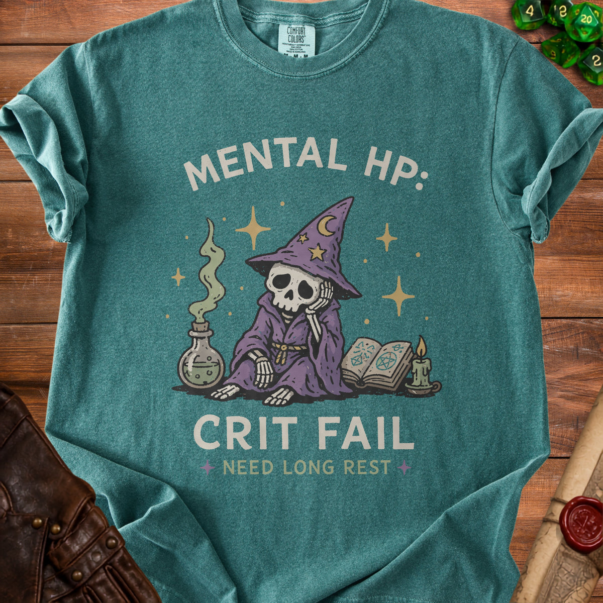 Green t-shirt with skeleton wizard graphic and "MENTAL HP: CRIT FAIL NEED LONG REST" text.