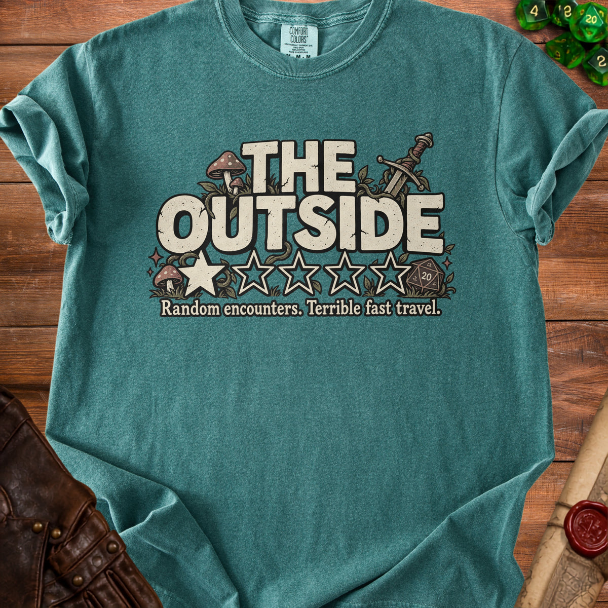 Teal t-shirt with "THE OUTSIDE" text, mushrooms, sword, dice, and stars.