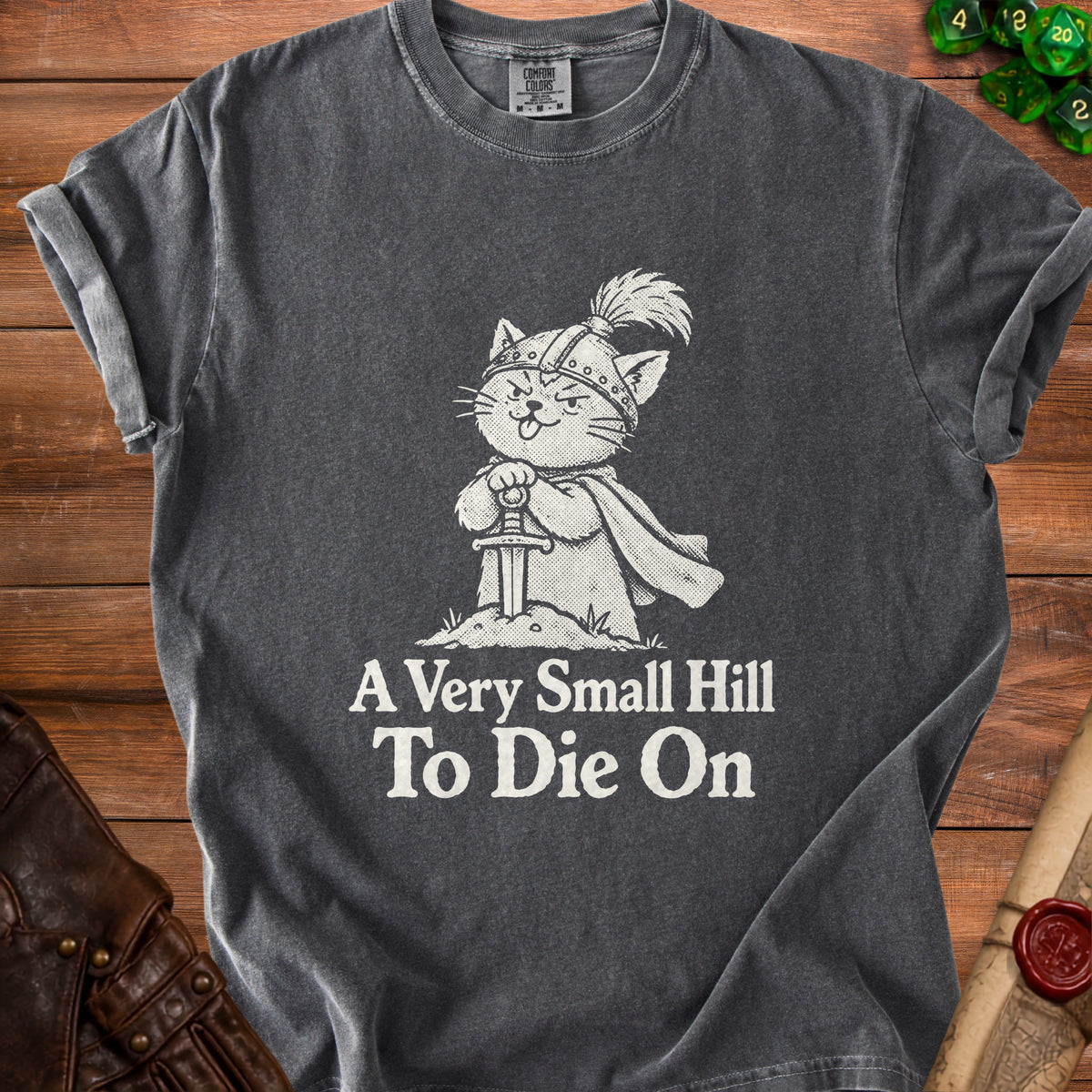Charcoal t-shirt with a white graphic of a cat knight holding a sword, reading "A Very Small Hill To Die On".