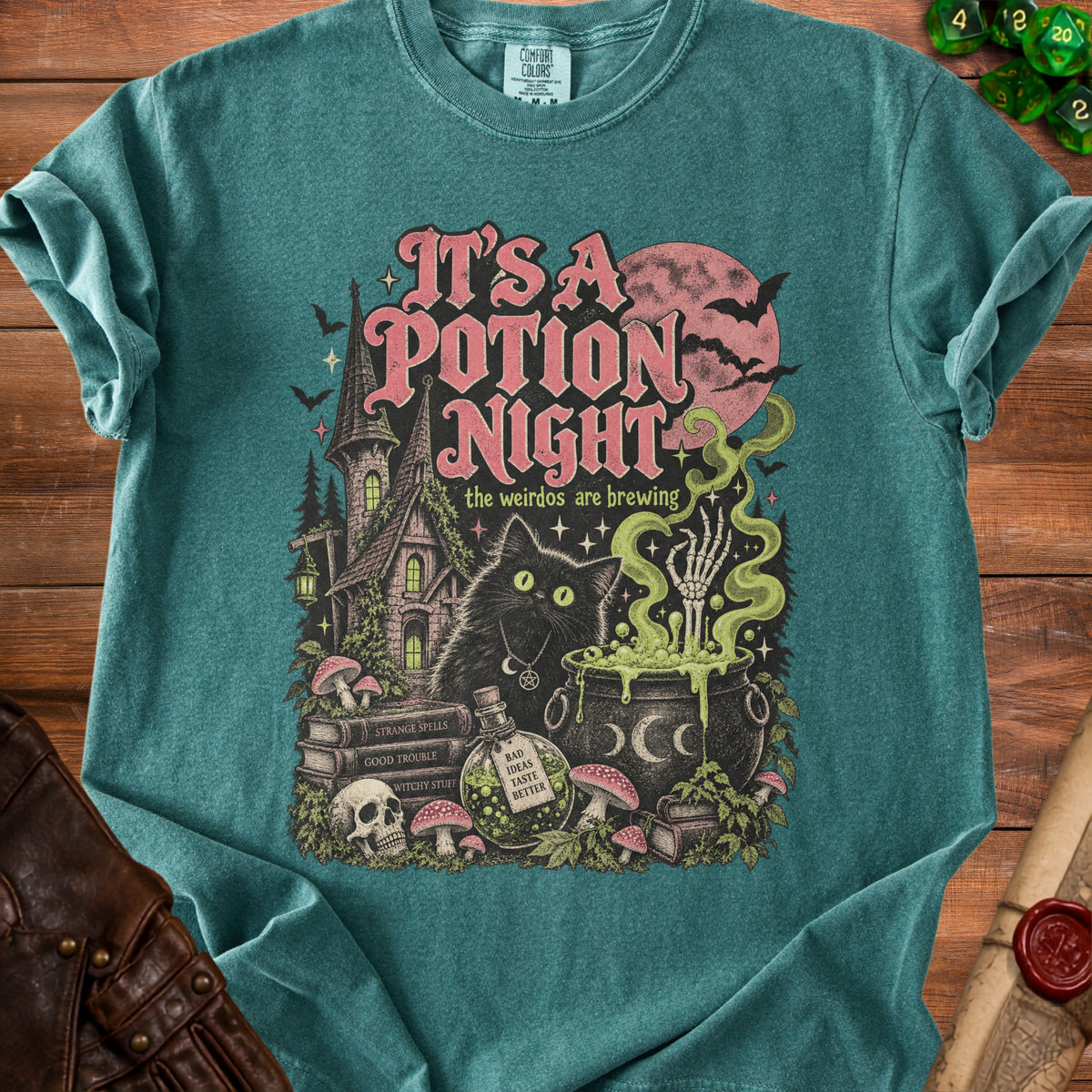 Green t-shirt with "It's a Potion Night" text and Halloween-themed illustration.