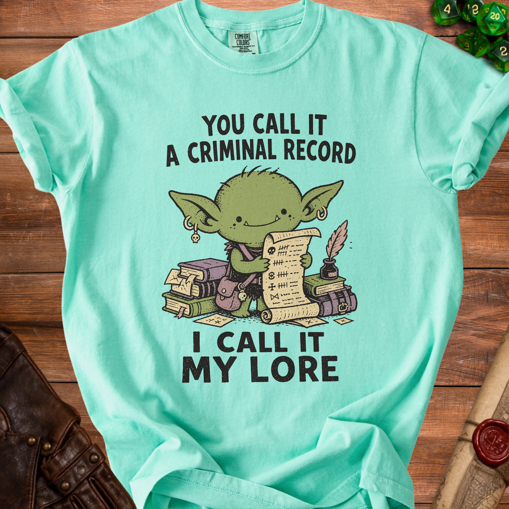 Mint t-shirt with goblin holding a scroll and books, "You call it a criminal record, I call it my lore".