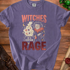 Purple t-shirt with graphic text "Witches of a Certain Rage" and witch illustration.