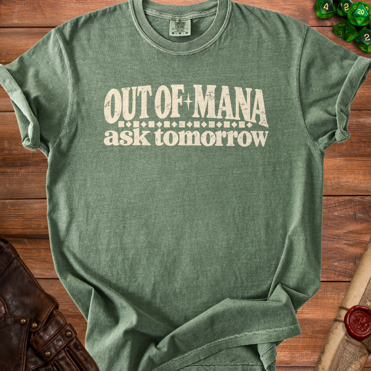 Green t-shirt with "OUT OF MANA ask tomorrow" text.