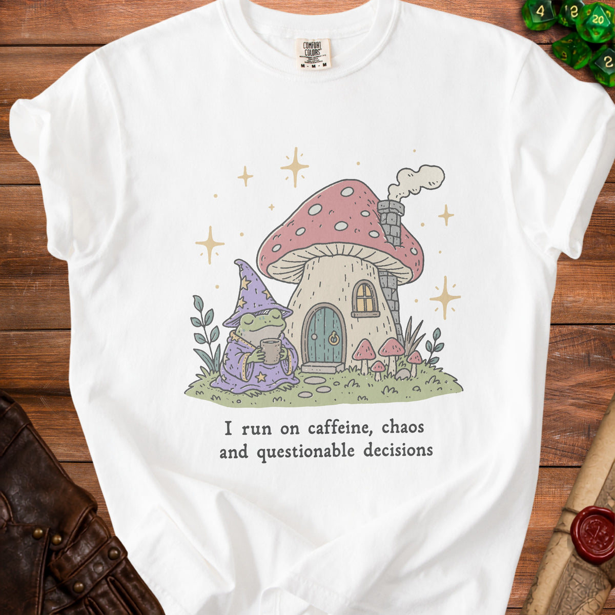 White t-shirt with frog wizard and mushroom house graphic and text.