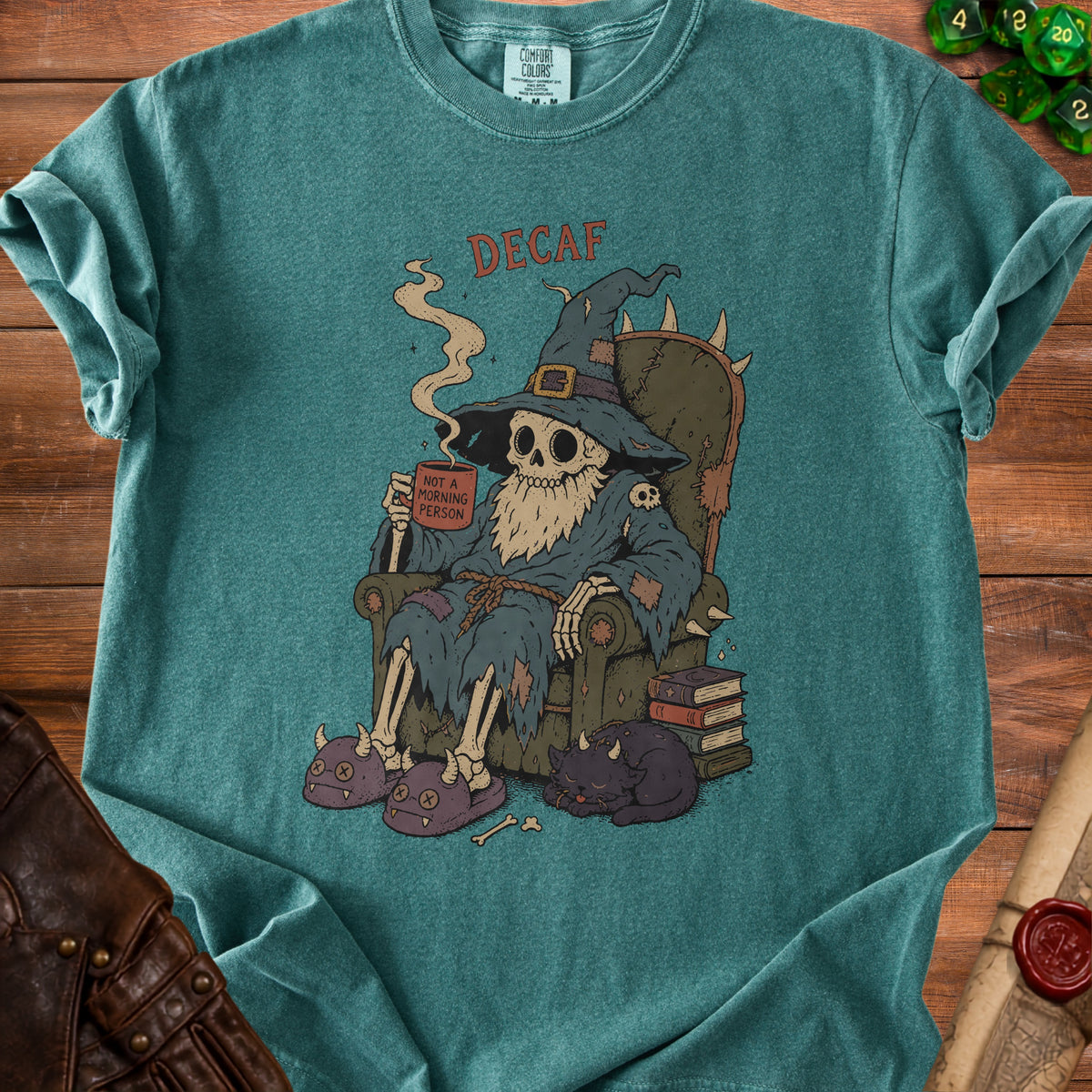 Skeleton wizard in throne drinks from mug that says "Not A Morning Person", with cat.