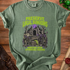 Green t-shirt with "Preserve Local Dungeons Monsters Need Affordable Housing" text and fantasy art.