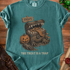 T-shirt graphic of a monster chest with candy and a pumpkin, saying "The Treat Is A Trap".