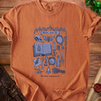 T-shirt with a "Minor curse kit" design featuring gothic illustrations and text.