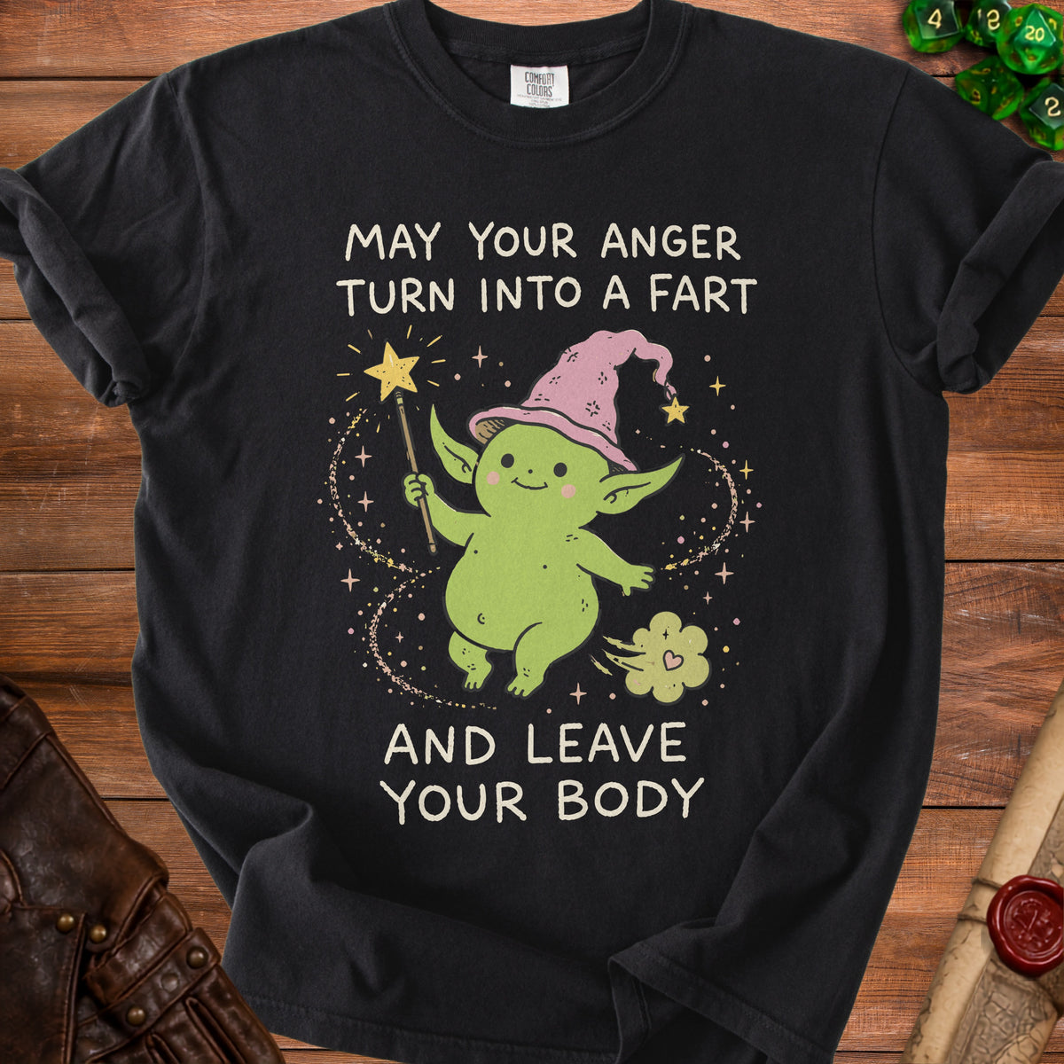Black t-shirt with a cartoon goblin wearing a pink hat and the text "May your anger turn into a fart and leave your body".