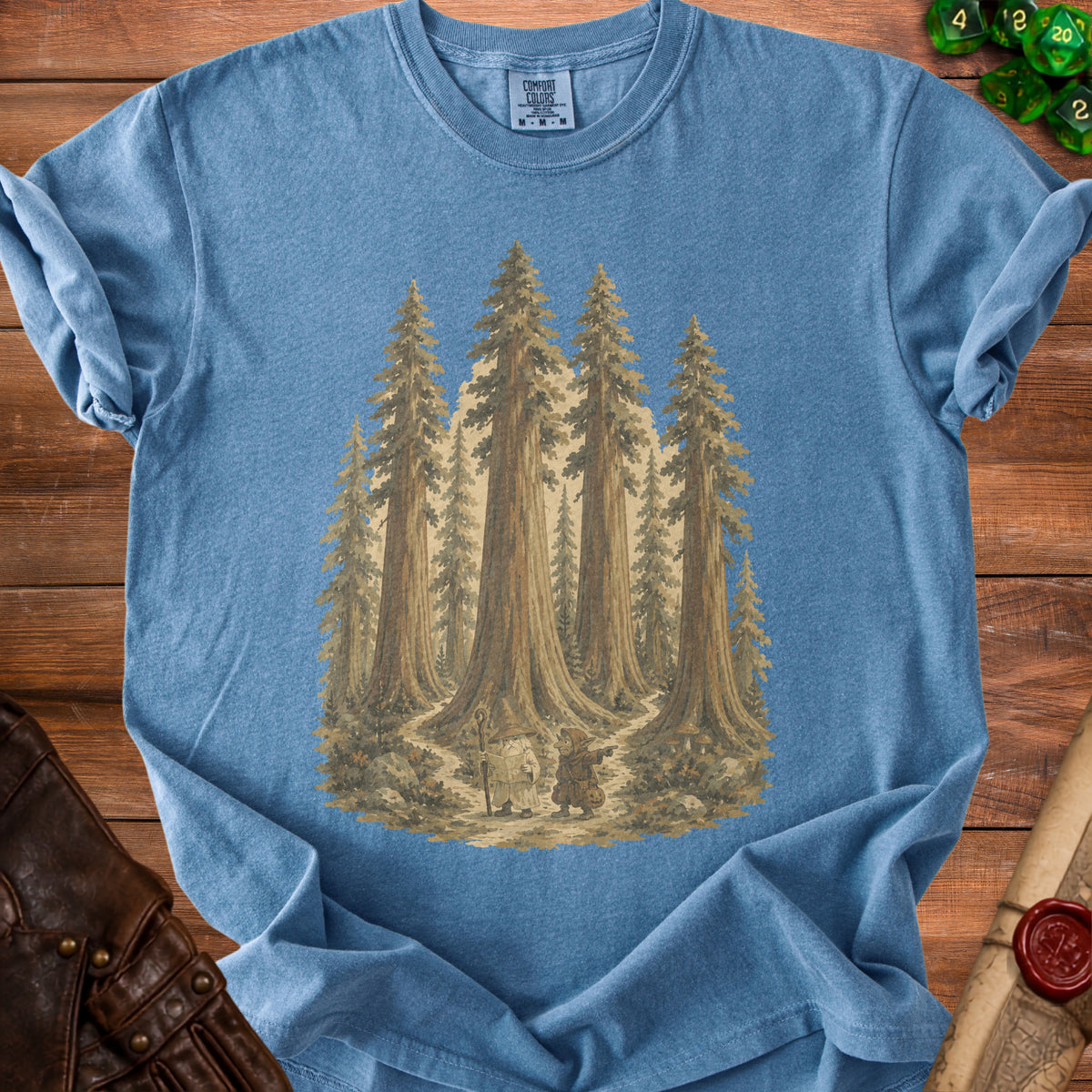 Blue t-shirt with graphic of wizard and goblin in a redwood forest.