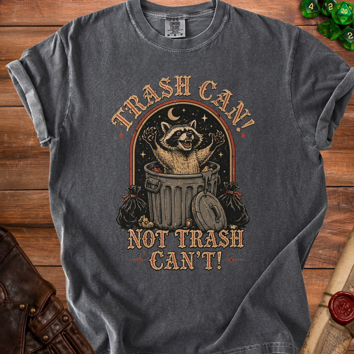 Graphic tee with raccoon in trash can and text "TRASH CAN! NOT TRASH CAN'T!".